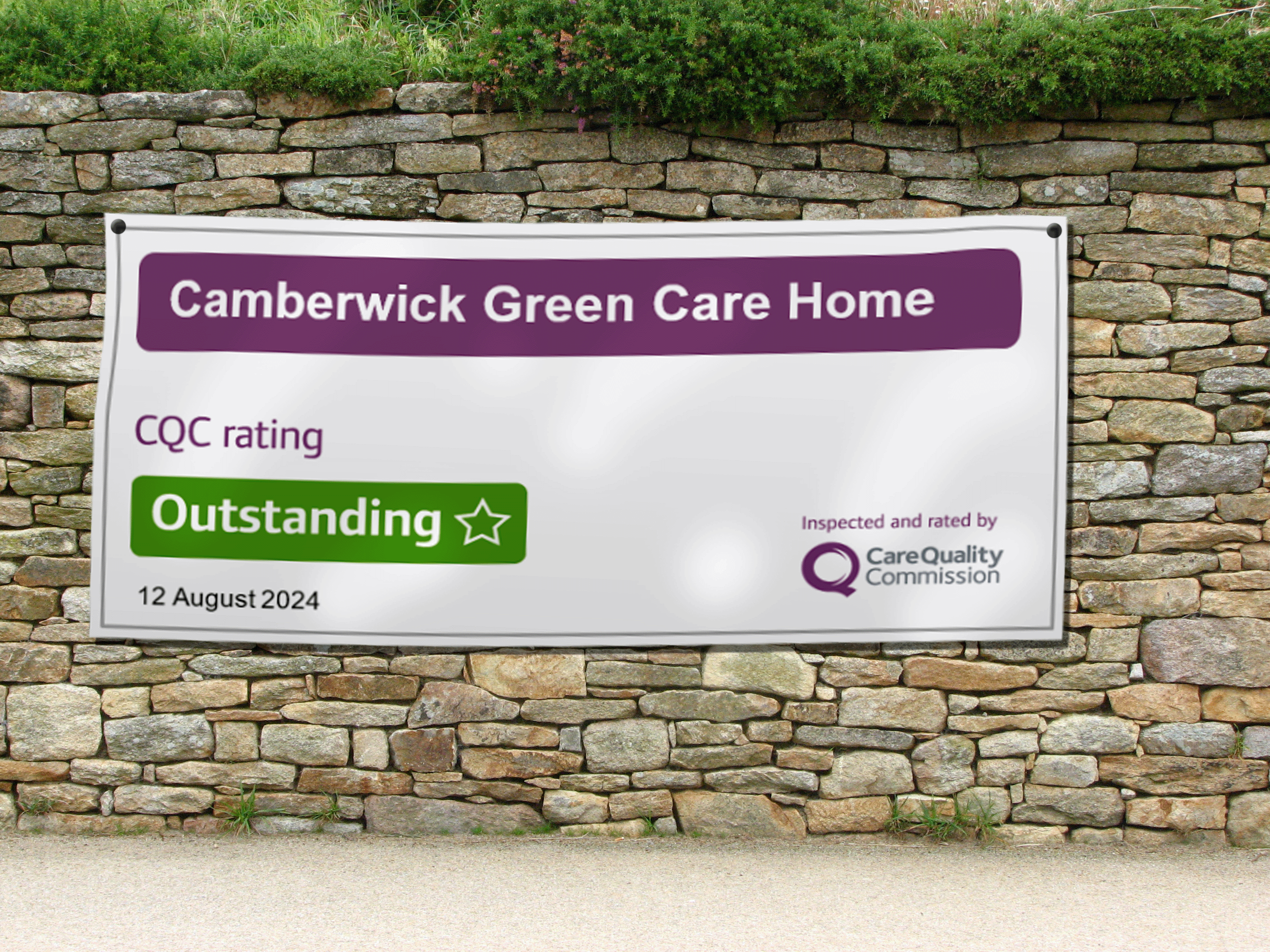 Mock banner for a care home showing an outstanding rating, hung on a stone wall