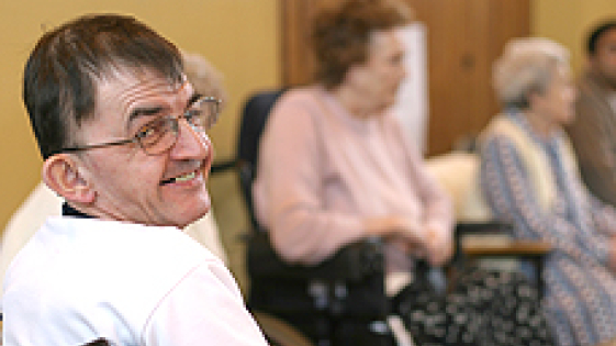 A photograph of a man in a wheelchair