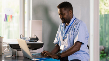 a health professional using a laptop